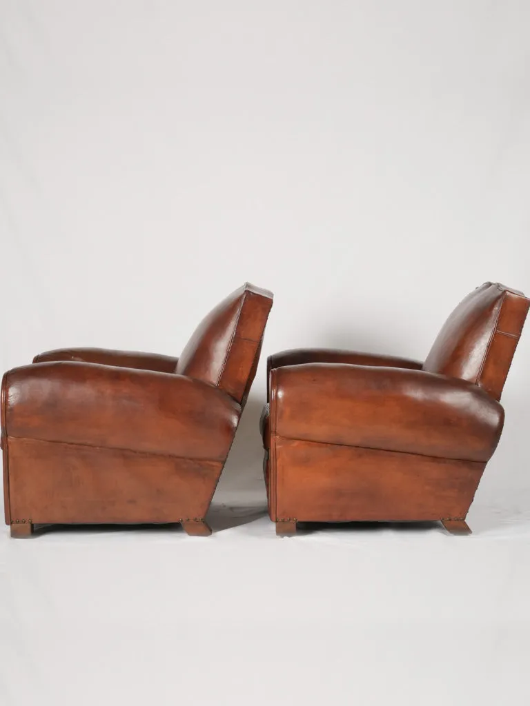 Pair of antique French leather club chairs - moustache back